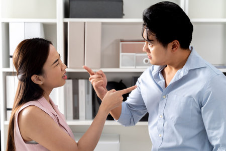 Angry Asian business woman yelling and scolding at a mad businessman in the office room setting....