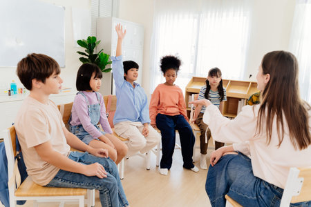Multicultural primary school children participate in engaging group lesson. Teacher facilitates...