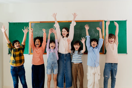 Diverse Young Pupils and Enthusiastic Educator Express Excitement during School Day, Fostering Inclusive Learning Environmentの写真素材