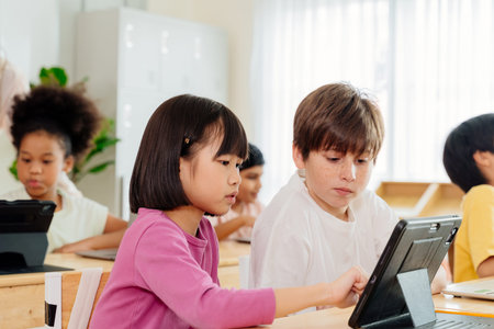 Students working together on tablets in a bright classroom setting