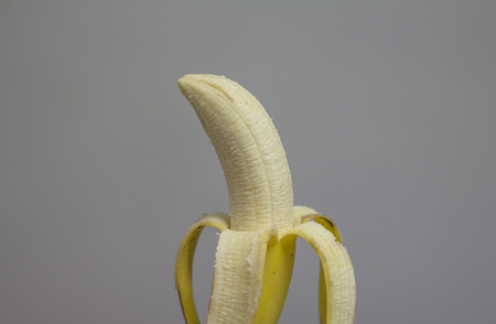 Half peeled bananaの写真素材