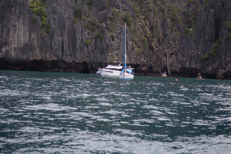 Boat in the sea near the rocky shore. Traveling near the island.の写真素材