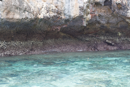 Sea near the rocky shore. Traveling near the island.の写真素材