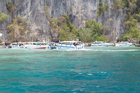 Boat in the sea near the rocky shore. Traveling near the island.の写真素材