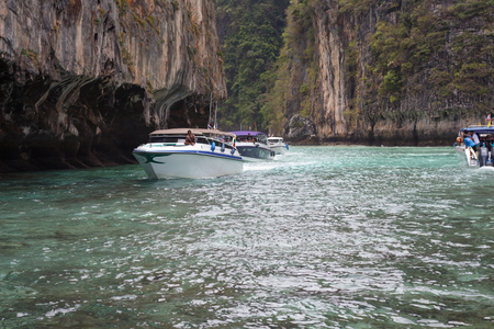 Boat in the sea near the rocky shore. Traveling near the island.のeditorial素材