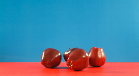 Red apples on background colorful. Copyspaceの写真素材