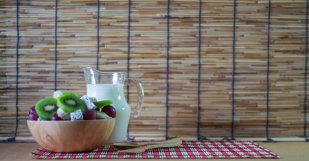 Delicious healthy fruits salad in bowl on tableの写真素材