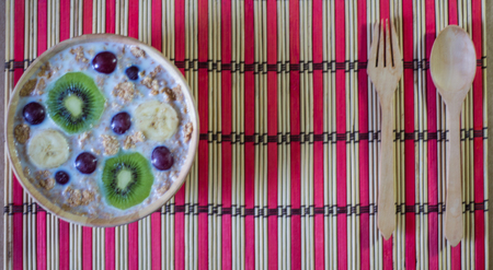 breakfast cereals with fruit, oats and yogurt in bowl.の写真素材