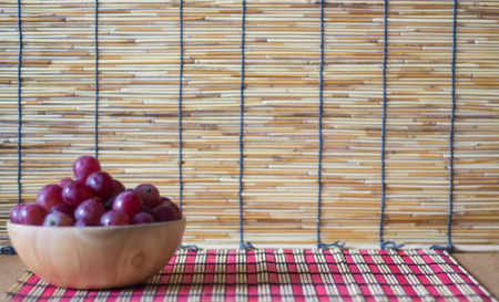 Red grape fruit fresh in wooden basketの写真素材
