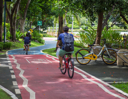 The family cycling in the parkの写真素材