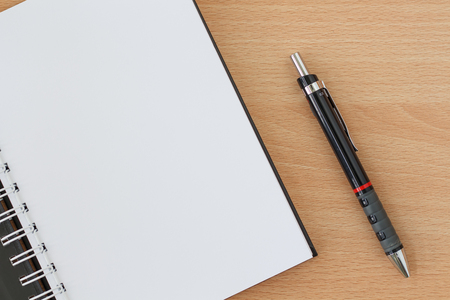 workspace on wood table with notebook and pen. copy spaceの写真素材