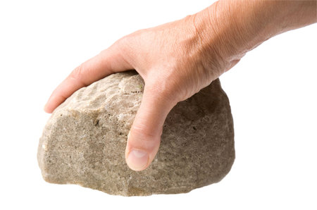 male hand with a rock isolated on a white background