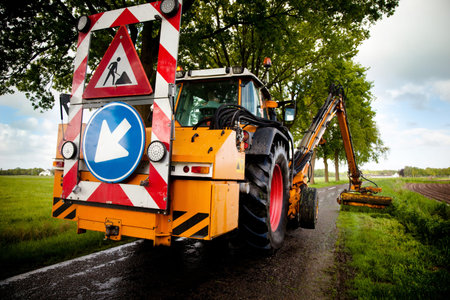 mowing with machine grass along roadside