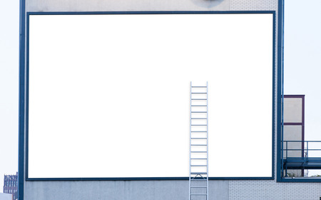 Large Empty white billboard with ladder on industrial buildingの写真素材