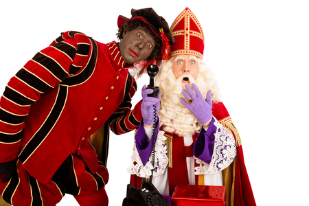 Sinterklaas and Zwarte Piet with old vintage telephone. isolated on white background. Dutch character of Santa Clausの写真素材