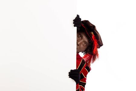 Zwarte Piet ( black pete)  with whiteboard. typical Dutch character part of a traditional event celebrating the birthday of Sinterklaas in decemberの写真素材