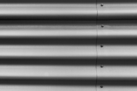 Detail of silver corrugated metal with boltsの写真素材