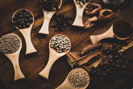 Various aromatic spices (star anise, cinnamon, nutmeg), coffee beans . Vintage Spices and herbs texture background. Top viewの写真素材
