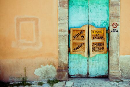 Old western swinging Saloon doors.With spanish text and copy space on the wallの写真素材