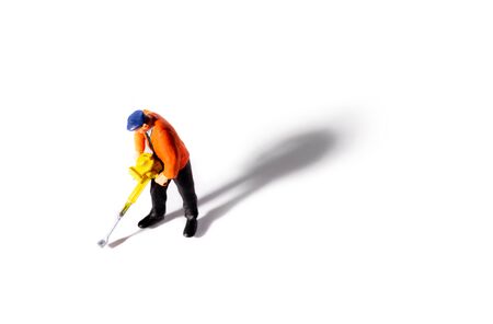 Little People Builder worker with pneumatic hammer drill equipment on white background. Shot from above with shadowの写真素材