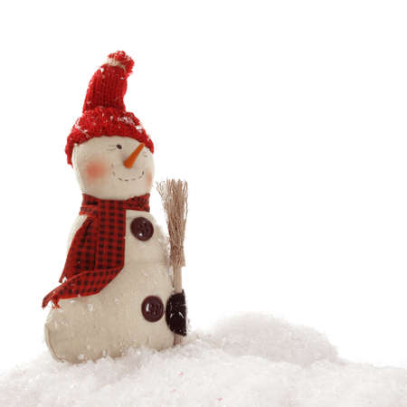 Happy snowman with a carrot nose and broom stands in a snow drift                               の写真素材