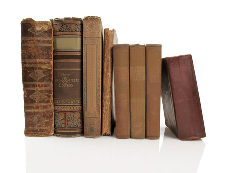 Group of beautiful old books on a white reflective background                               の写真素材