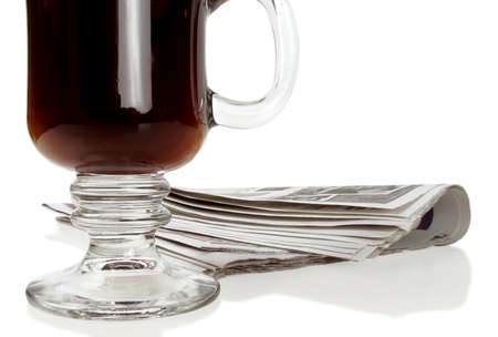 Fresh black coffee and the morning paper on white                               の写真素材