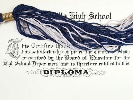 Close up detail of a high school diploma with tassle from cap                               の写真素材