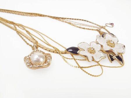 Beautiful vintage necklaces with gold chains on white                               の写真素材