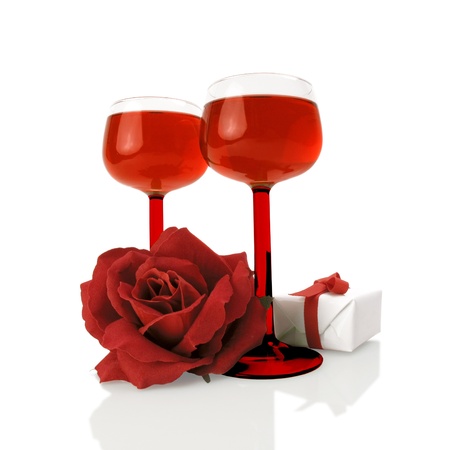 Red wine with a silk rose and a little gift on white                               の写真素材