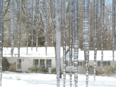 Icicles hang from the eaves on a cold winter morning                               の写真素材