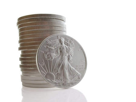 Stack of twenty uncirculated liberty silver dollars on white