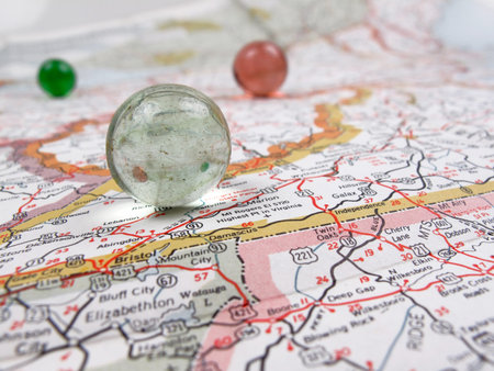 Low perspective of a vintage road map with marblesの写真素材