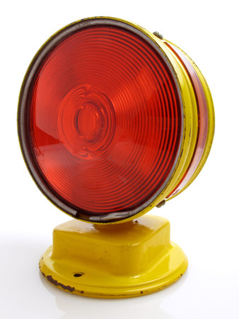 Side view of an old warning signal on white