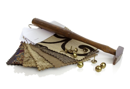 Upholstery samples and workman's tools on a white backgroundの写真素材