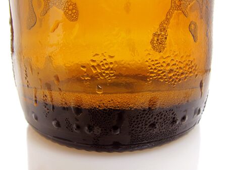 Cloce up view of the bottom of an ice cold beerの写真素材