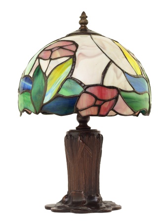Artful, beautiful little stained glass lamp with a brass base on whiteの写真素材