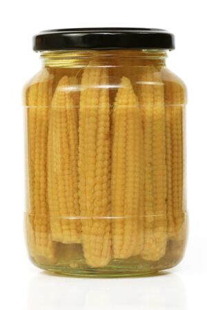 Yellow ears of baby corn preserved in a glass jarの写真素材