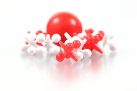 Closeup view of red and white jacks on a white backgroundの写真素材