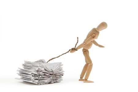 A person pulls his weight with heavy debtの写真素材