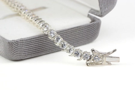 Diamond tennis bracelet in box isolated on whiteの写真素材