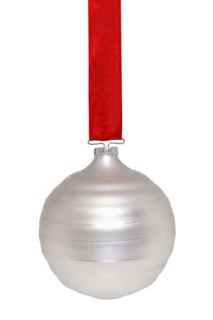 Silvery white Christmas ornament hanging from a red ribbon on whiteの写真素材