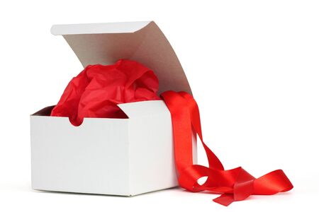 White gift box with red tissue and a red ribbonの写真素材
