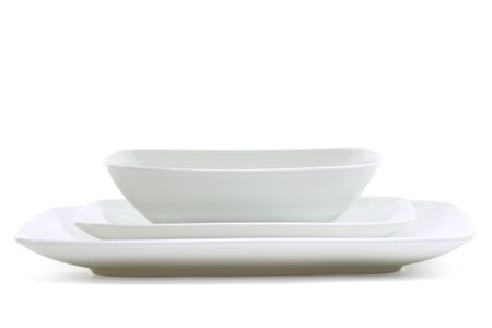 Set of white square dinner plates on whiteの写真素材