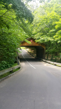 A road that passes through an old covered bridgeの写真素材