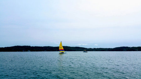 A boat with a yellow sailの写真素材