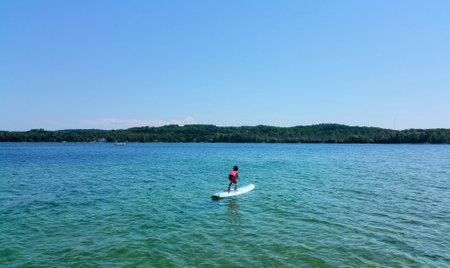 A small child on a paddle boardの写真素材