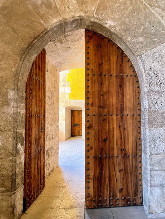 Open Wooden Doors in Stone Archwayの写真素材
