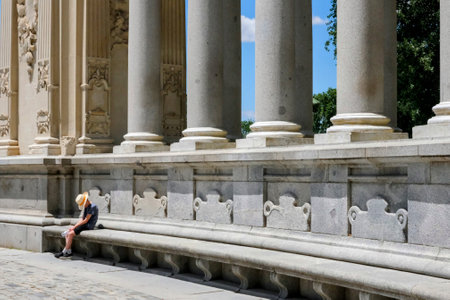 A Person Resting by Monumental Columnsの写真素材