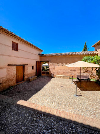 Sunny Courtyard with Umbrella in Granadaの写真素材